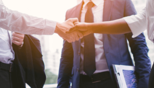 Two businesspeople in suits shaking hands